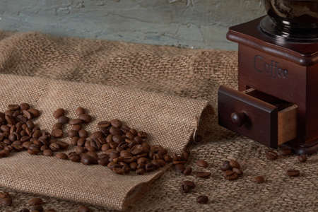 coffee beans and grinder on table with rustic backgroundの写真素材