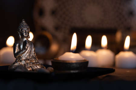 image in Buddhist temple next to candles