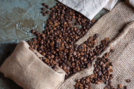 Coffee beans and grinder on table with rustic backgroundの写真素材