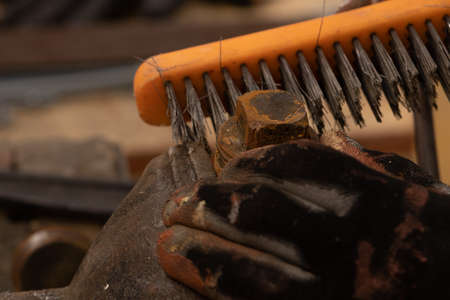 blacksmith worker working in workshop with metals and work tableの写真素材