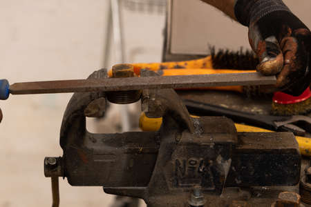 blacksmith worker working in workshop with metals and work tableの写真素材