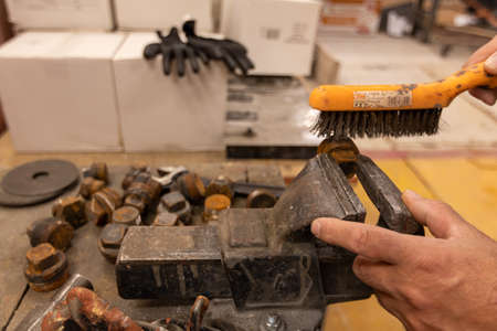 blacksmith worker working in workshop with metals and work table
