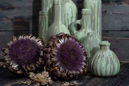 artichokes in a vase on a dark wooden background.の写真素材
