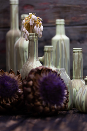 Still life with dried flowers in vintage bottles on a wooden background.の写真素材