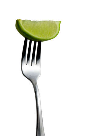 Lime on Fork over white backgroundの写真素材