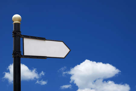 Blank sign showing into right direction in front of blue skyの写真素材