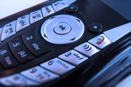 Close up on key pad of a cell phone with focus on 'OK' buttonの写真素材