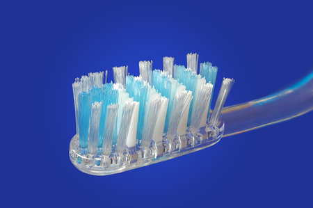 Close up of a tooth brush over gradient blue background