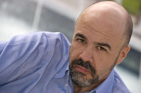 Middle aged man looking straight into your eyesの写真素材