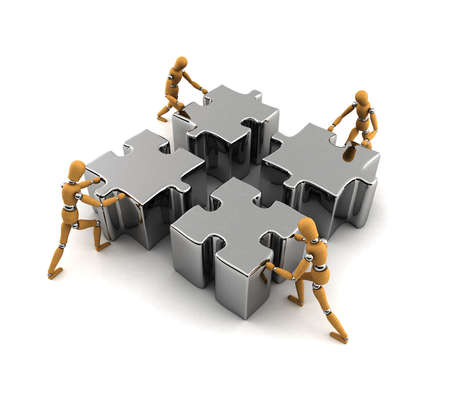 Wooden mannequins pushing puzzle pieces into the right placeの写真素材