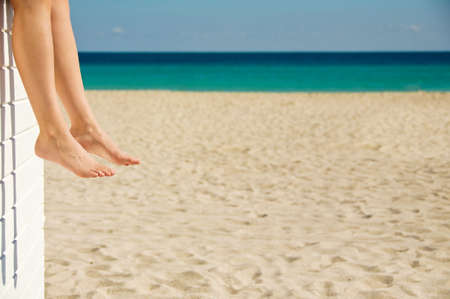Woman relaxing on the beach on a sunny dayの写真素材
