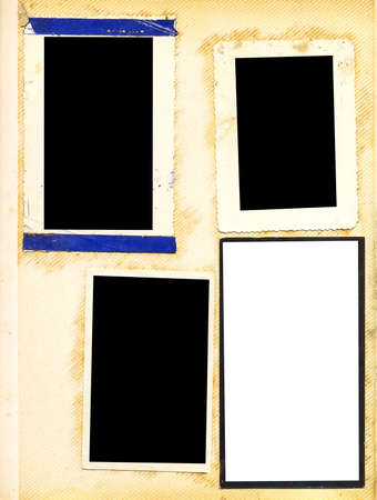 Old, yellowed page of an old photo album with four photo framesの写真素材