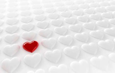 Red heart in between many white heartsの写真素材