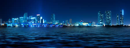 Miami skyline at night with beautiful water reflectionsの写真素材