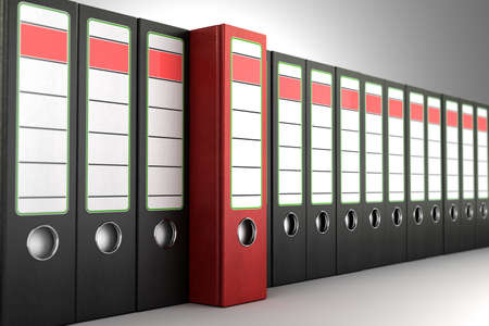 Red ring binder standing out from a row of dark bindersの写真素材