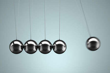 Close-up view of a Newton's Cradle with motion blurの写真素材