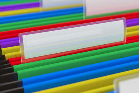 Multi colored hanging folder with blank tag on itの写真素材