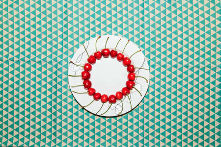 Ripe and delicious cherries on a plateの写真素材