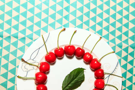 Ripe and delicious cherries on a plateの写真素材