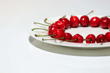 Ripe and delicious cherries on white backgroundの写真素材