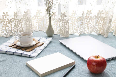 The laptop and other supplies on the table