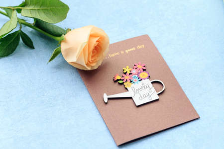 Rose  and card isolated on blue background