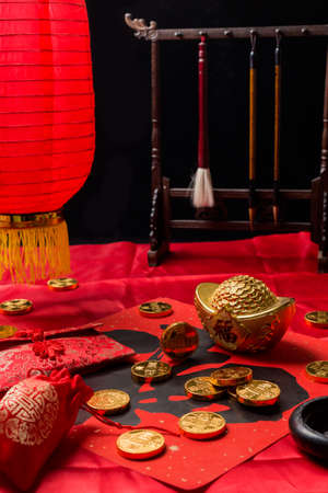 Gold ingots, gold coins, piggy banks and coupletsの写真素材