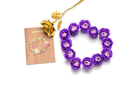 Heart-shaped rose soap flowers, golden rose and card on white backgroundの写真素材