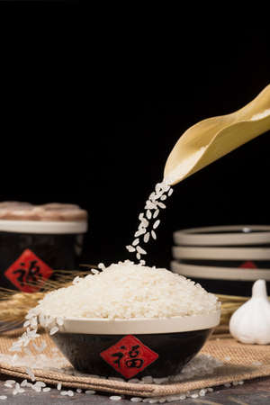 Pour uncooked rice in traditional ceramic potの写真素材