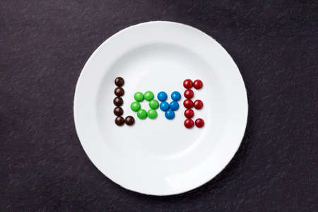 Word LOVE made with chocolate candy on a plateの写真素材