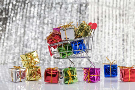 colorful gift boxes and shopping carts on the table