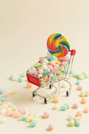 Colorful candies and lollipops on shopping cartの写真素材