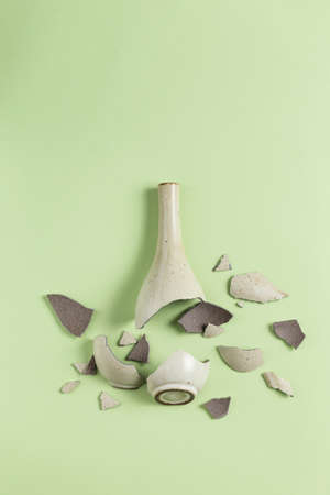 A broken vase against a green backgroundの写真素材