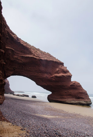 famous natural rock arch on the beach of moroccoの写真素材