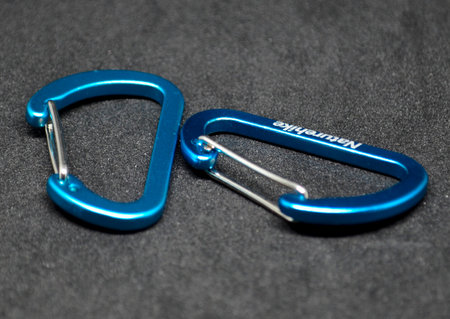 carabiner is a versatile tool used for securely attaching items, used in outdoor activities, due to their reliability and strength in securing equipment and ropesの写真素材