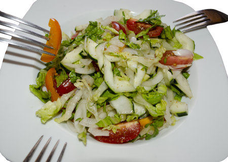 vegetable salad with cucumber and tomato on white backgroundの写真素材