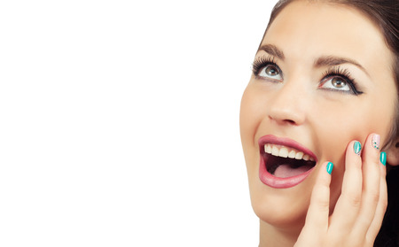 Close-up portrait of surprised beautiful girl on a white background with space for textの写真素材
