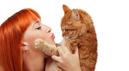 Beautiful young woman with a red catの写真素材