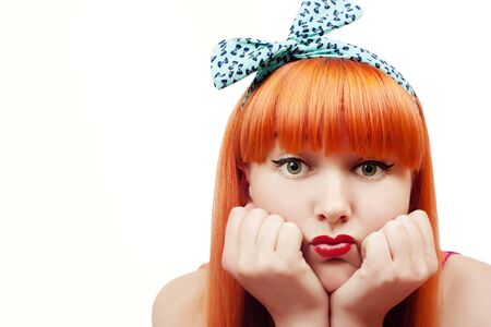 Beautiful young woman with pin-up make-up pout her lipsの写真素材