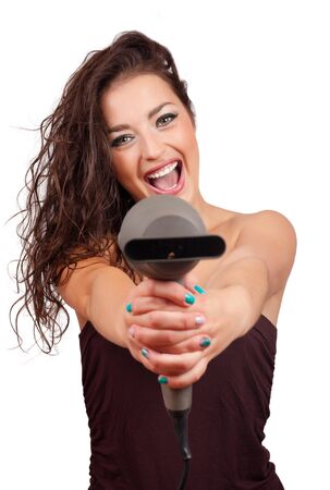 Portrait of beautiful young fashion  woman holding hairdryerの写真素材
