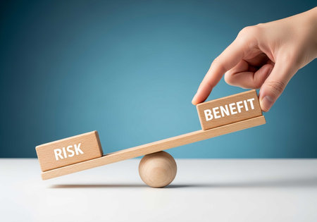 Businessman hand holding wooden seesaw with risk and benefit concept.の素材