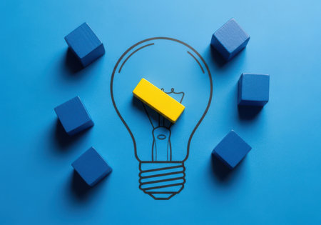 a creative lightbulb idea concept with blocks representing innovation and problem solving skillsの素材