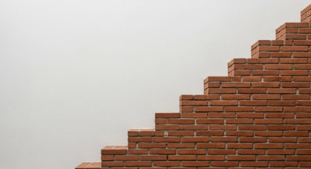 a brick wall with a staircase design against a white wall, perfect for design and construction needsの素材