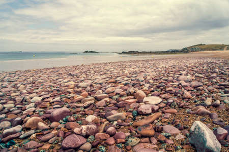Wet and colored pebbles on the beach somewhere in Brittany, Franceの写真素材