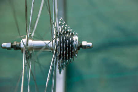 Close-up of a brand new and shiny bicycle wheel with gearsの写真素材