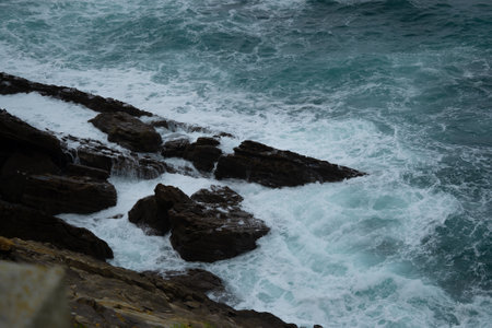Waves crashing against the rocksの写真素材