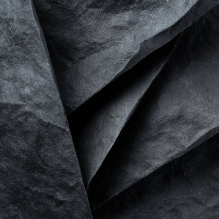 Close-up view of dark, textured fabric with deep folds and subtle variations in blue and gray hues, creating a sense of depth.の素材