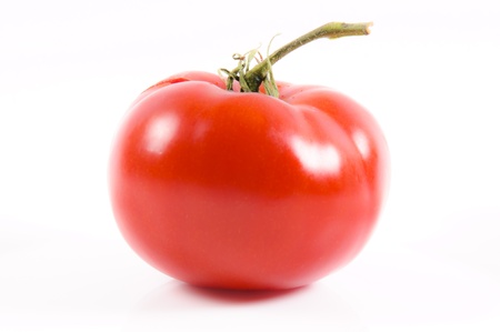 Whole organic tomatoe isolated on whiteの写真素材