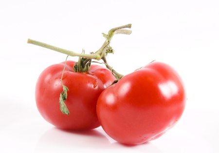 Whole organics tomatoes isolated on whiteの写真素材