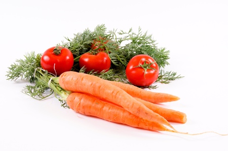 Carrots and tomatoes isolated on whiteの写真素材